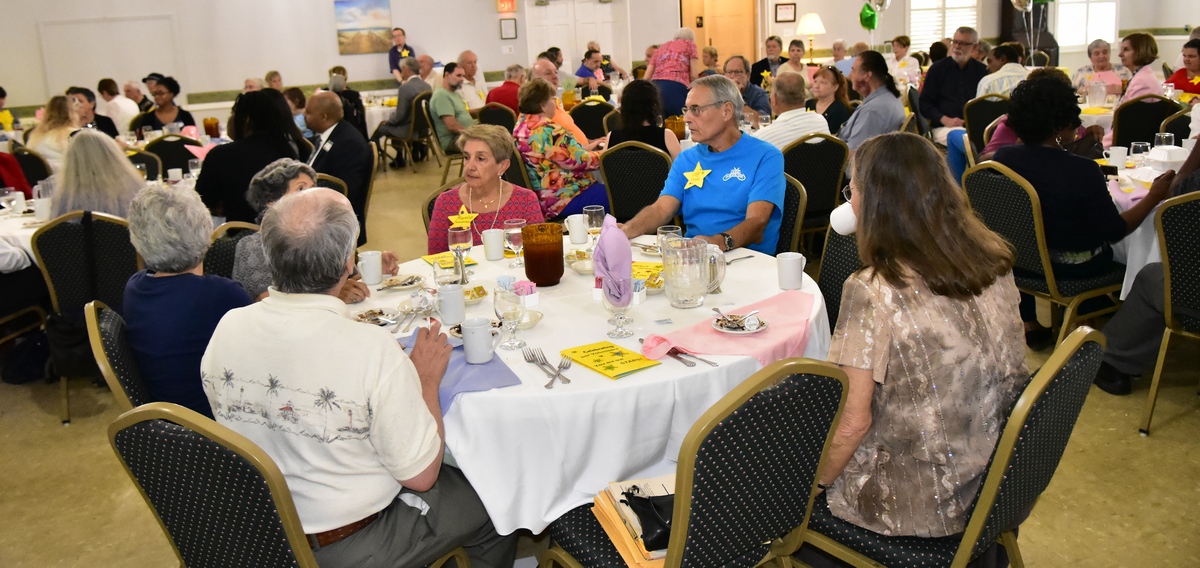 A room full of guests sitting at tables during the Volunteer Appreciation Luncheon.